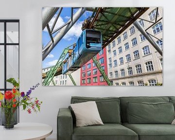 Hover train glides past historic buildings in Wuppertal by Marc Venema