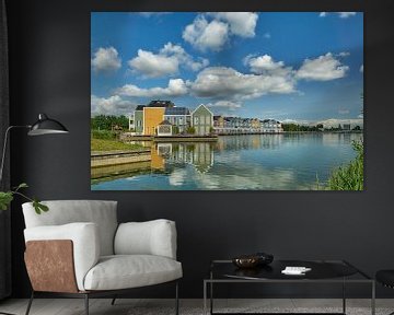Coloured houses at Rietplas, blue sky with clouds by Ad Jekel
