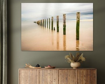 Beach poles in the sea at the North Sea beach by Sjoerd van der Wal Photography