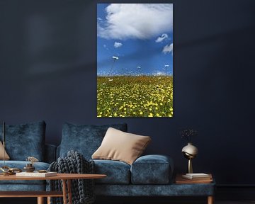 A field in bloom under a blue sky by Claude Laprise