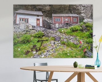 Cottages built under rock shelter in Norway by Evert Jan Luchies