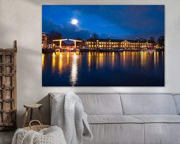 Amsterdam illuminated bridges at the Amstel river during winter