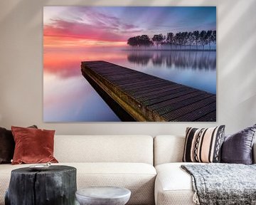 Jetty and row of trees at Lake Dirkshorn during a beautiful misty sunrise by Bram Lubbers