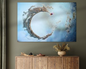 Open ring arranged with sea sand and a pink clam shell on a blue by Maren Winter