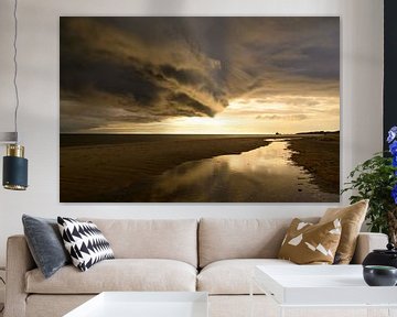 Sunrise at the beach at Texel island with a storm cloud approaching