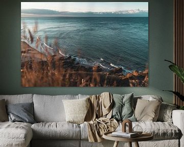 The sea with grass in the foreground in France by Martijn Joosse