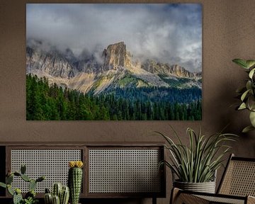 A play between the sun and the clouds, above the mountains of the Dolomites by Leon Okkenburg