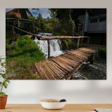 Wooden bridge over narrow river