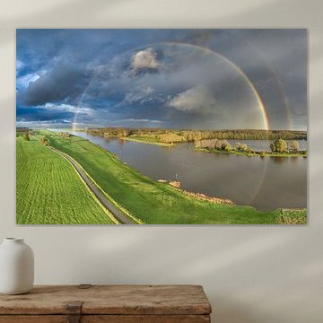 Rainbow during an autumn rain shower over the river IJssel