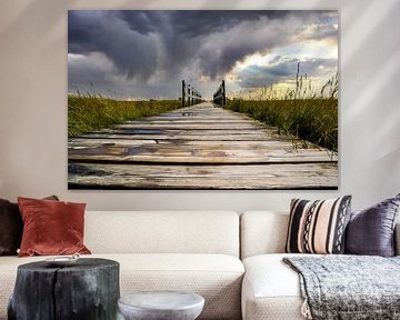 wooden bridge over the north sea in cloudy skies