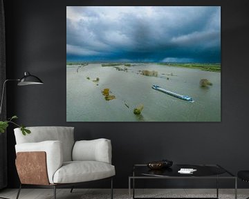 Ship on the IJssel with overflowing floodplains at the river