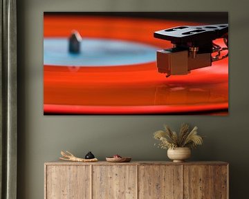 Orange long-playing disc on record player by Frank Kremer