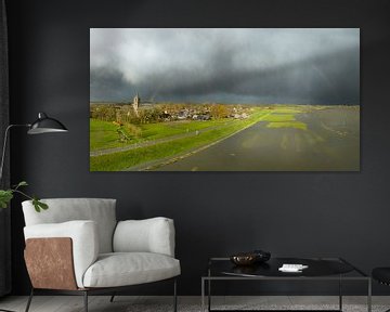 Arc-en-ciel sur le village de Zalk et la rivière IJssel lors d'une averse d'automne