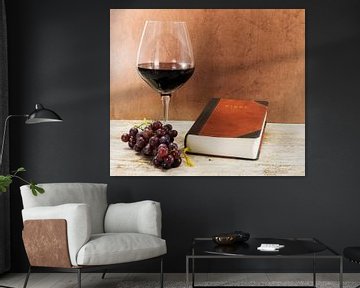 glass of red wine with bible and grapes von ChrisWillemsen