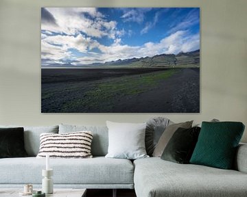 Iceland - Black sand flat with green moss between mountains by adventure-photos