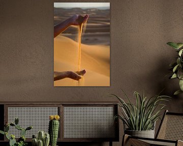 Hands playing with Sahara sand. by Ton de Koning