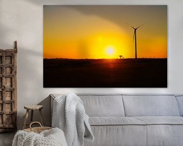 Wind turbine at sunset on a meadow by Martin Köbsch