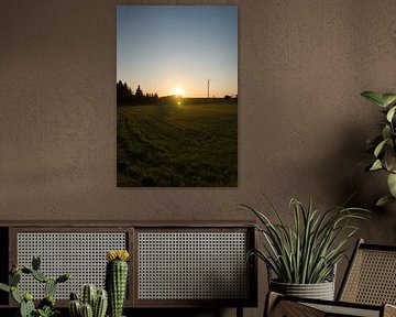 Wind turbine at sunset on a meadow by Martin Köbsch