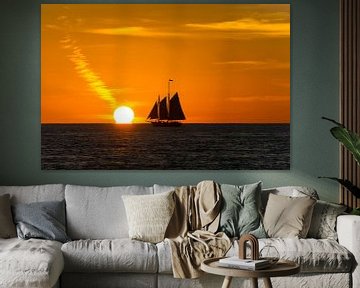 USA, Florida, Sailing ship next to orange sun as sunset near key west by adventure-photos