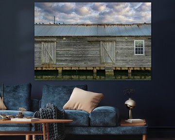 USA, Florida, Old boathouse in harbor with cloudscape and water by adventure-photos