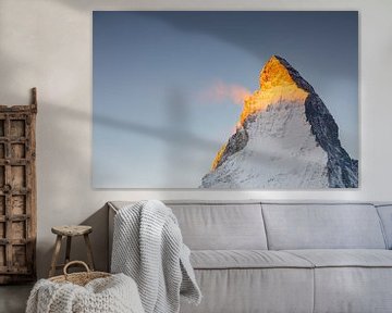 Glowing Matterhorn peak with snow dust in winter