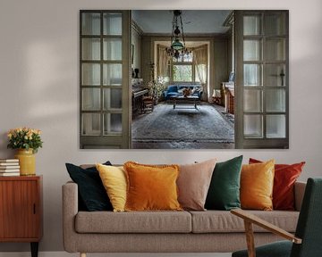 Living room with blue sofa and piano in abandoned house by Inge van den Brande