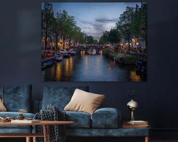 Amsterdam's beautiful canals in the evening during the blue hour with reflections