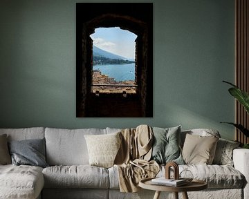 View through a window of Scaliger Castle over Malcesine in Italy
