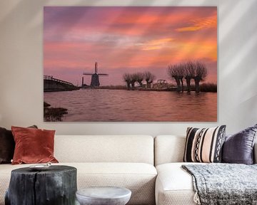 The Kaag mill, pollard willows and a boat in Spanbroek (North Holland) under a brightly coloured sky by Bram Lubbers