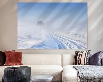 The lone tree in a winter landscape by peter reinders