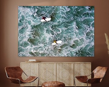 Top shot of 2 surfers in the sea by Eye on You