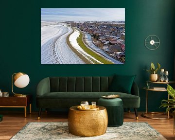 Luchtfoto van besneeuwd dorp Moddergat in Friesland aan een bevroren Waddenzee in Nederland in de winter van Eye on You