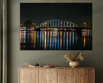 The Wilhelmina bridge on the river IJssel near Deventer in the Netherlands at night by Eye on You