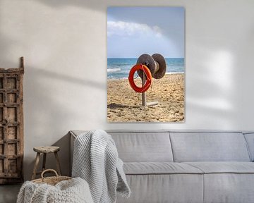 Lifebuoy with throwing device on the beach of Crete, Greece by Andreas Freund