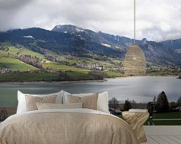 Panoramic image of a snow-covered and partly cloudy mountain landscape in Switzerland with Lake Gruyère by Andreas Freund