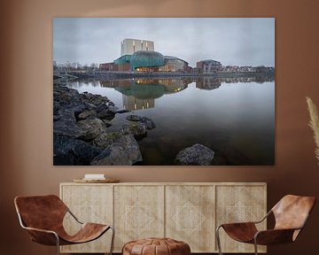 Schouwburg Hoorn reflects in the Markermeer during a grey morning by Bram Lubbers