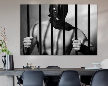 Man behind prison bars in submissive fetish style by Photostudioholland