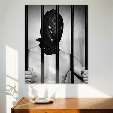 Man behind prison bars in submissive fetish style
