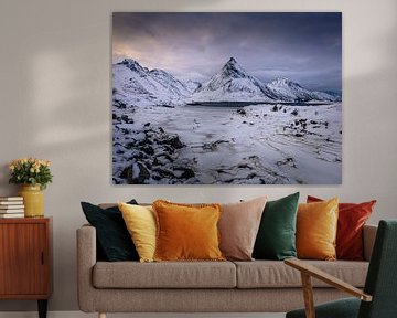 Snow-capped mountains by a lake.