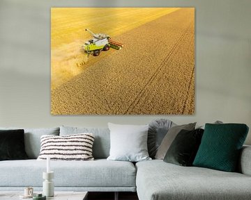 Combine harverster harvesting wheat during summer seen from above by Sjoerd van der Wal Photography