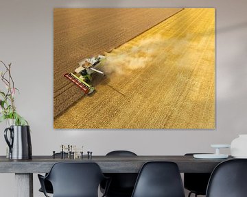 Combaine harverster harvesting wheat during summer seen from above by Sjoerd van der Wal Photography