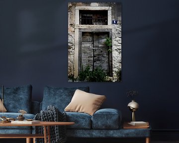 Double wooden door with padlock and house number by Theo Felten