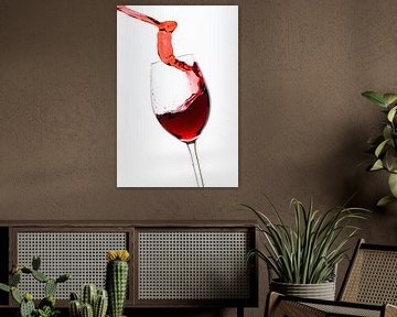 Red wine flows into the wine glass by Roland Brack