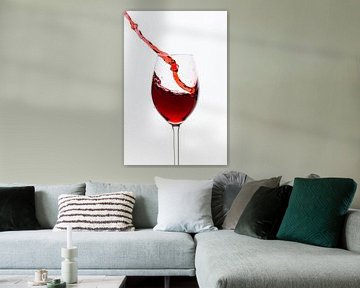 Red wine flows into the wine glass by Roland Brack