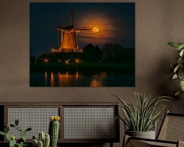 Full moon is shot through the sail of mill Leonide in Anna Paulowna by Bram Lubbers