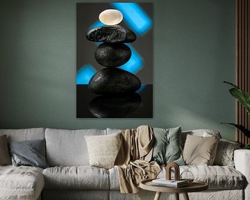 Three black stones with a glass stone