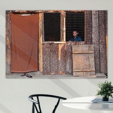 Boy behind open window in hut near Thimphu Bhutan. Wout Kok One2expose