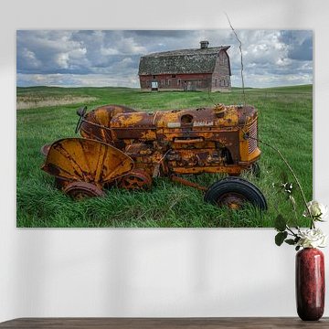 Dilapidated farmhouse and tractor in Canada