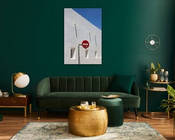 Traffic sign against white wall, window, shade by Daniël Loman