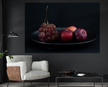 Still life with red grapes and plums